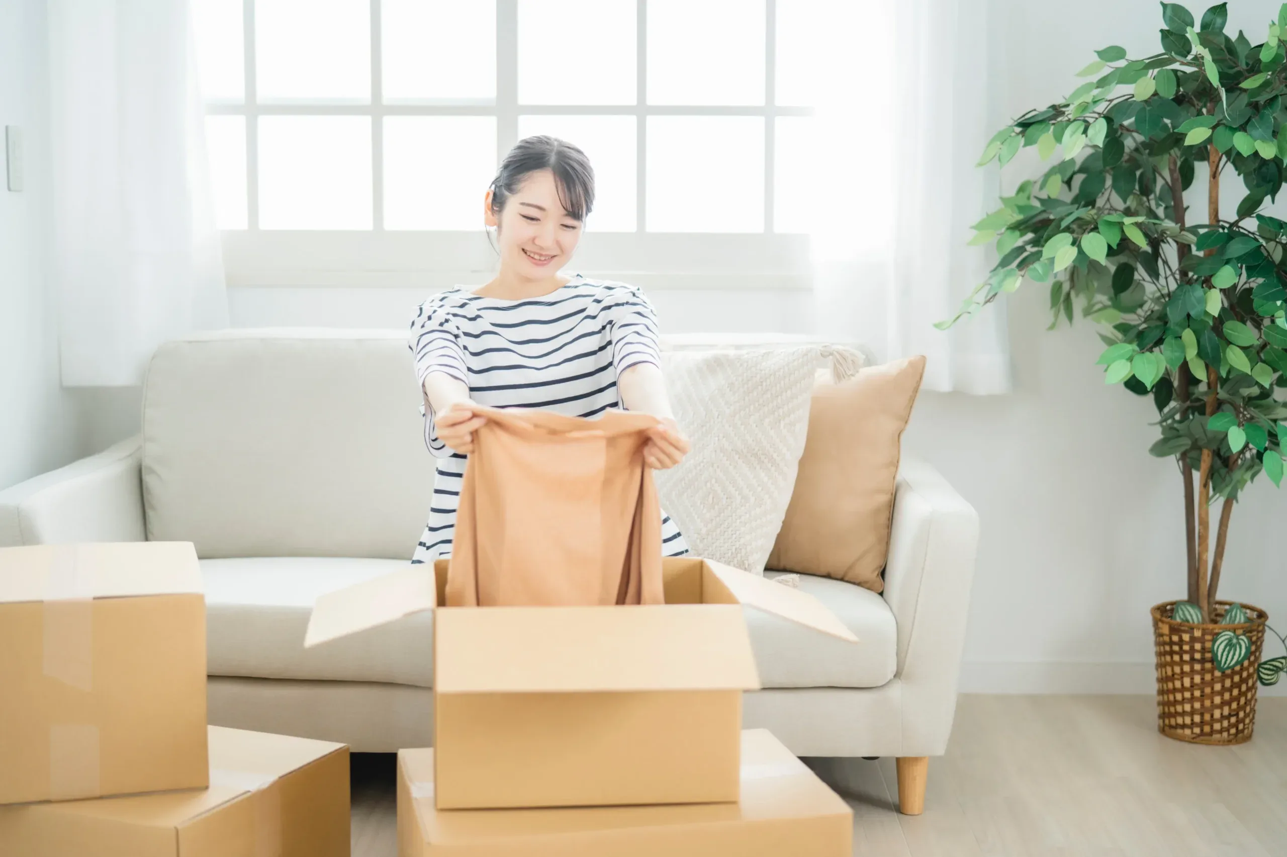 明るい部屋で衣類を整理するイメージ
